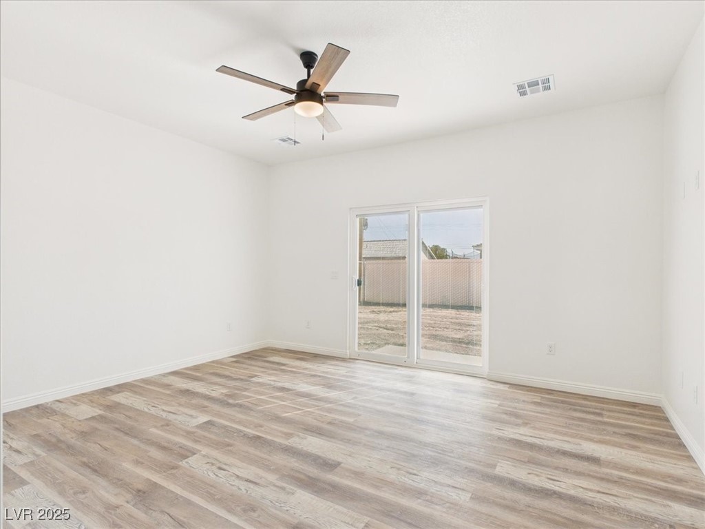 931 Lone Pine Road Pahrump, NV 89048 - Photo 15 of 48 Unfurnished room with light wood-style floors and ceiling fan