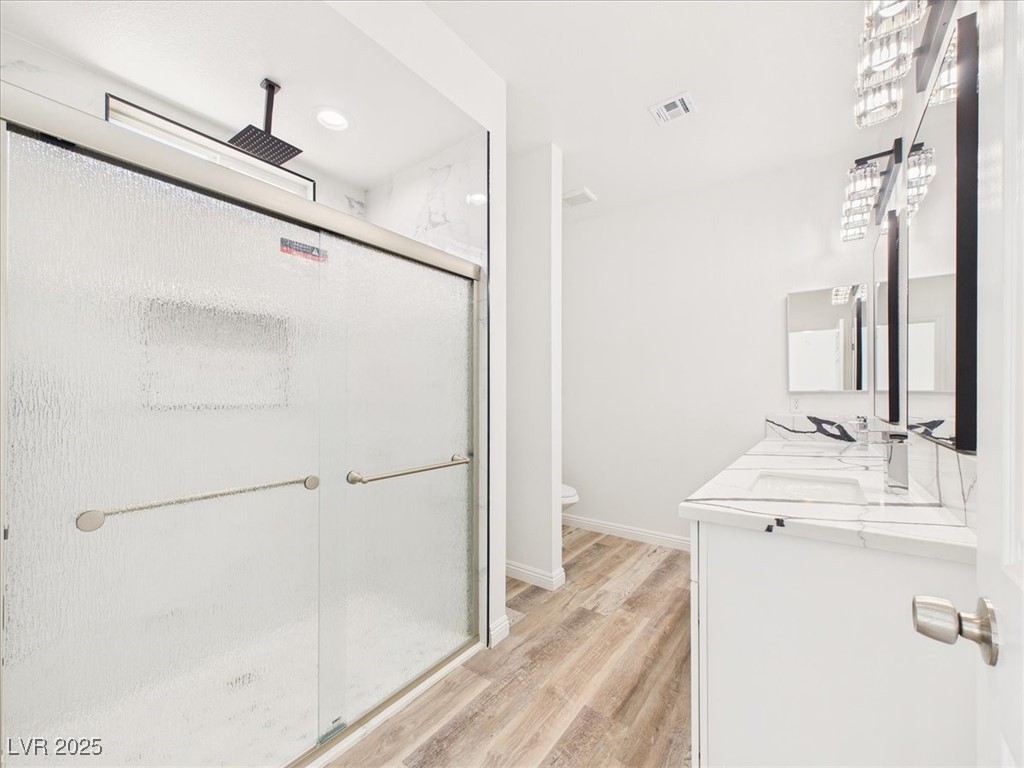 931 Lone Pine Road Pahrump, NV 89048 - Photo 17 of 48 Bathroom with a marble finish shower, light wood finished floors, double vanity, and recessed lighting