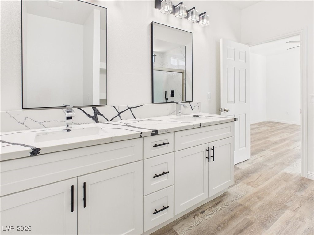 931 Lone Pine Road Pahrump, NV 89048 - Photo 21 of 48 Bathroom with light wood-type flooring, double vanity, and a shower with door