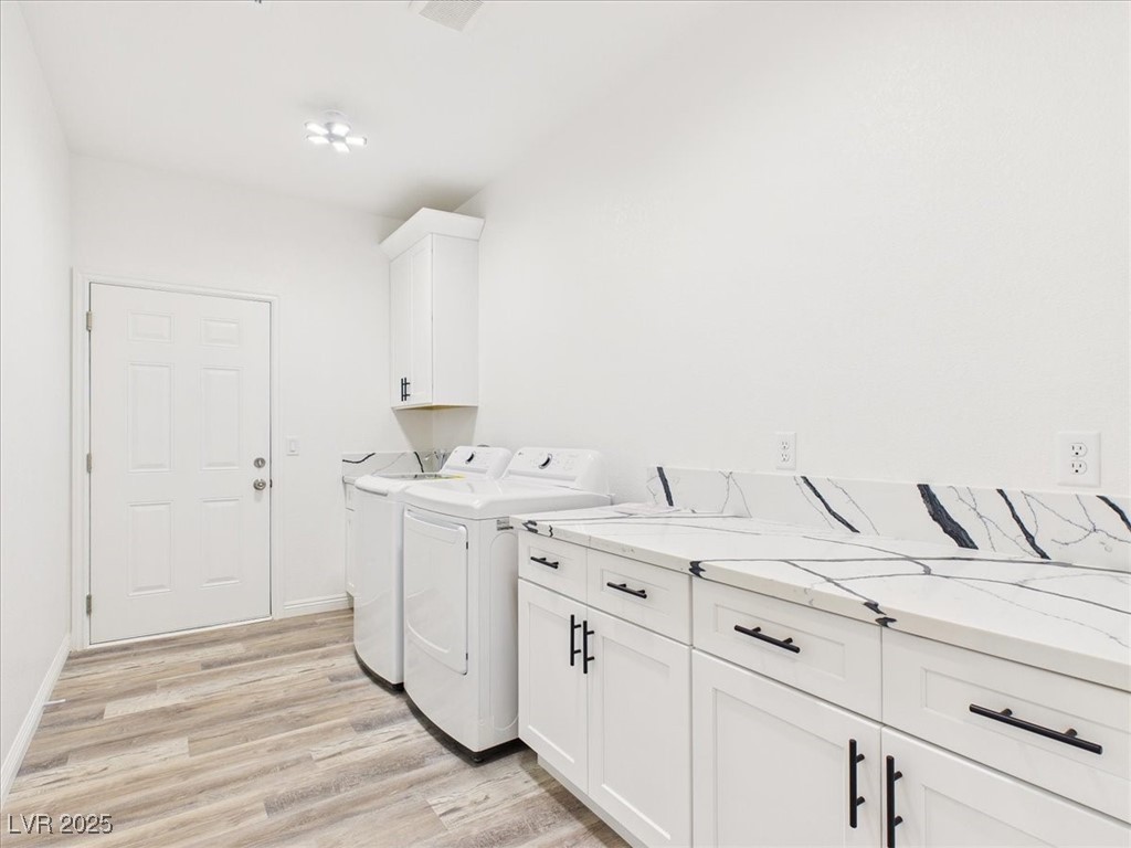 931 Lone Pine Road Pahrump, NV 89048 - Photo 23 of 48 Washroom featuring light wood-style flooring, cabinet space, and washer and clothes dryer