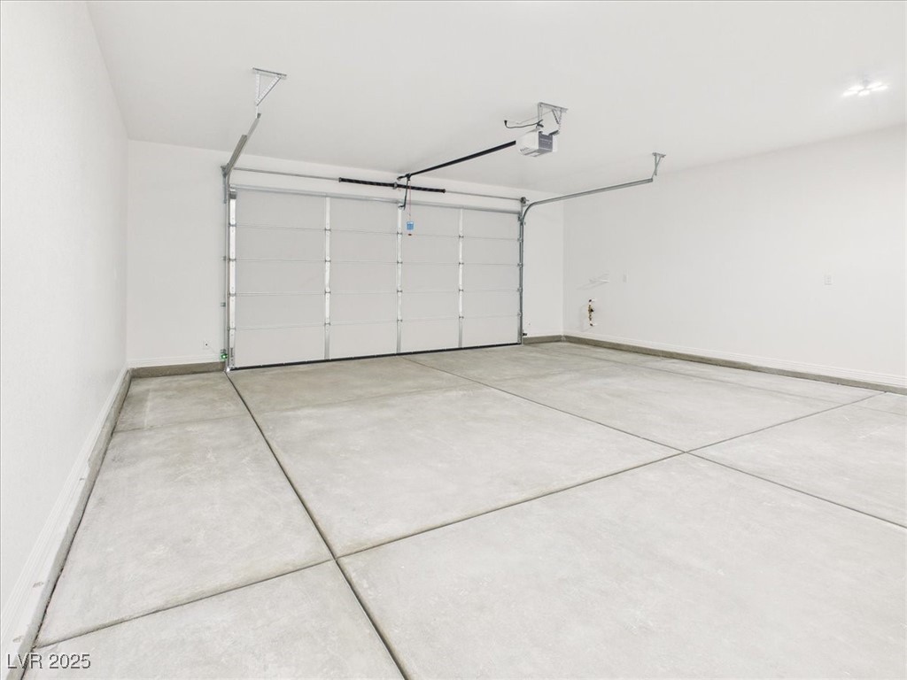931 Lone Pine Road Pahrump, NV 89048 - Photo 25 of 48 Garage with baseboards and a garage door opener