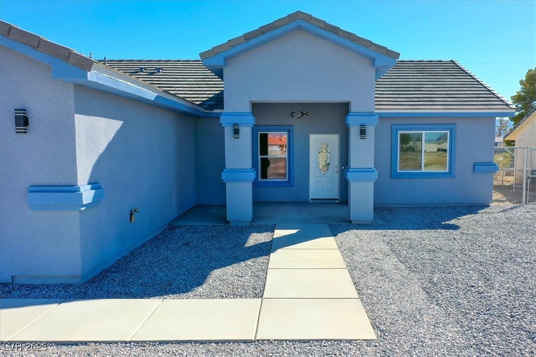 931 Lone Pine Road Pahrump, NV 89048 - Photo 29 of 48 View of front of home with a tiled roof and stucco siding