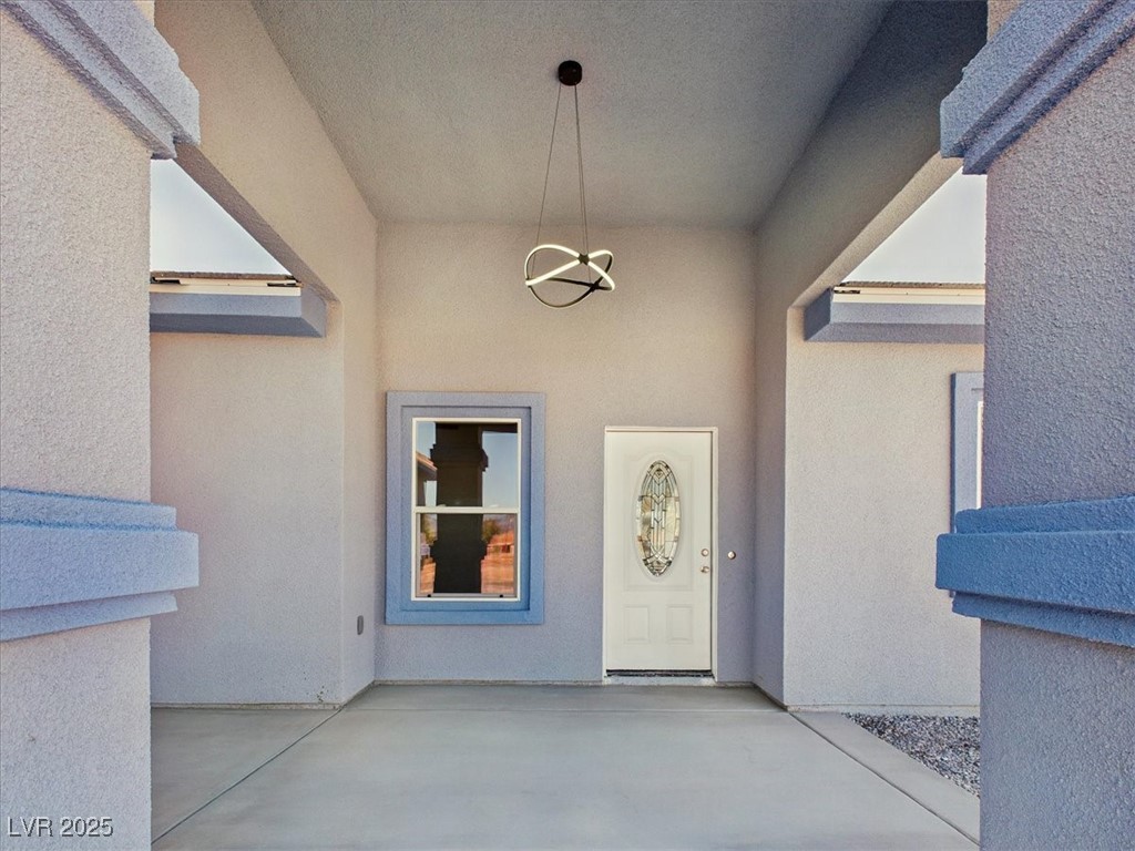 931 Lone Pine Road Pahrump, NV 89048 - Photo 30 of 48 View of exterior entry featuring a patio area and stucco siding