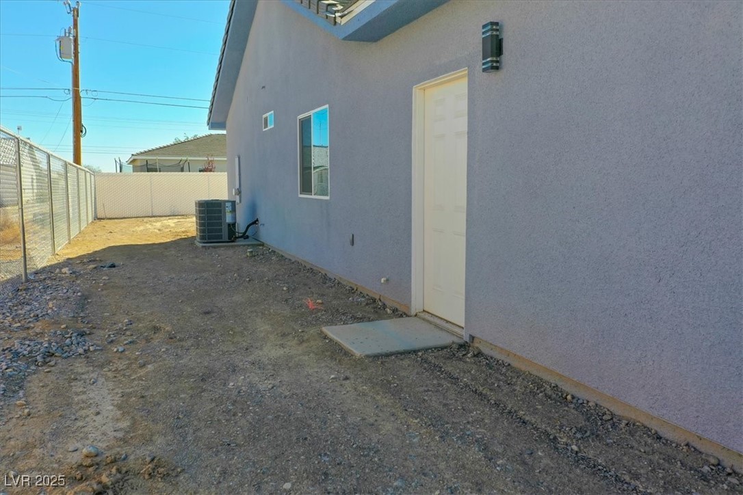 931 Lone Pine Road Pahrump, NV 89048 - Photo 35 of 48 View of side of property featuring a fenced backyard and stucco siding