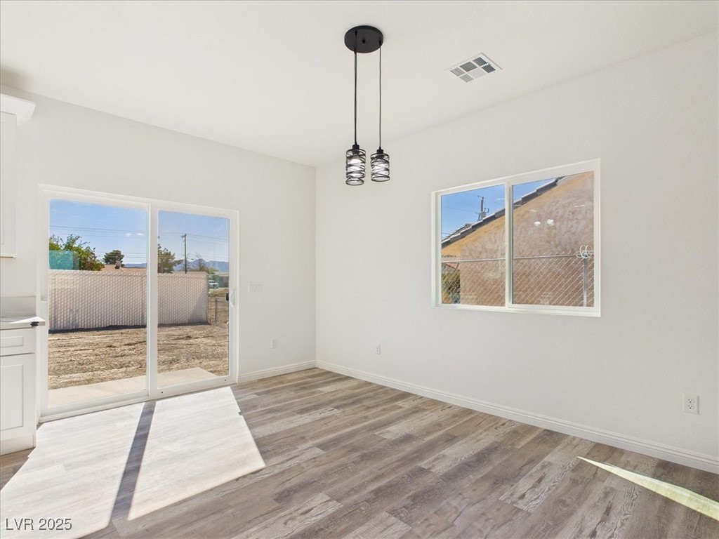931 Lone Pine Road Pahrump, NV 89048 - Photo 4 of 48 Unfurnished dining area featuring light wood-style flooring and baseboards