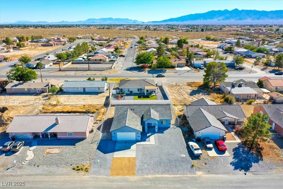 931 Lone Pine Road Pahrump, NV 89048 - Photo 42 of 48 Aerial perspective of suburban area with a mountain backdrop