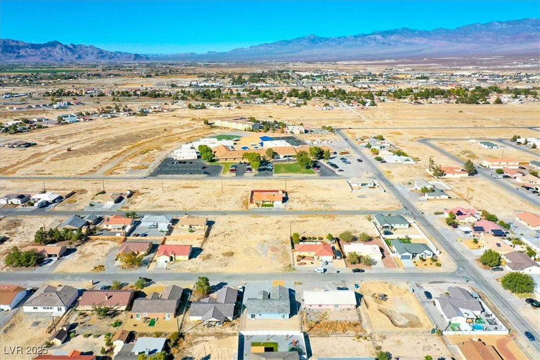 931 Lone Pine Road Pahrump, NV 89048 - Photo 47 of 48 Aerial view of property and surrounding area with mountains and nearby suburban area