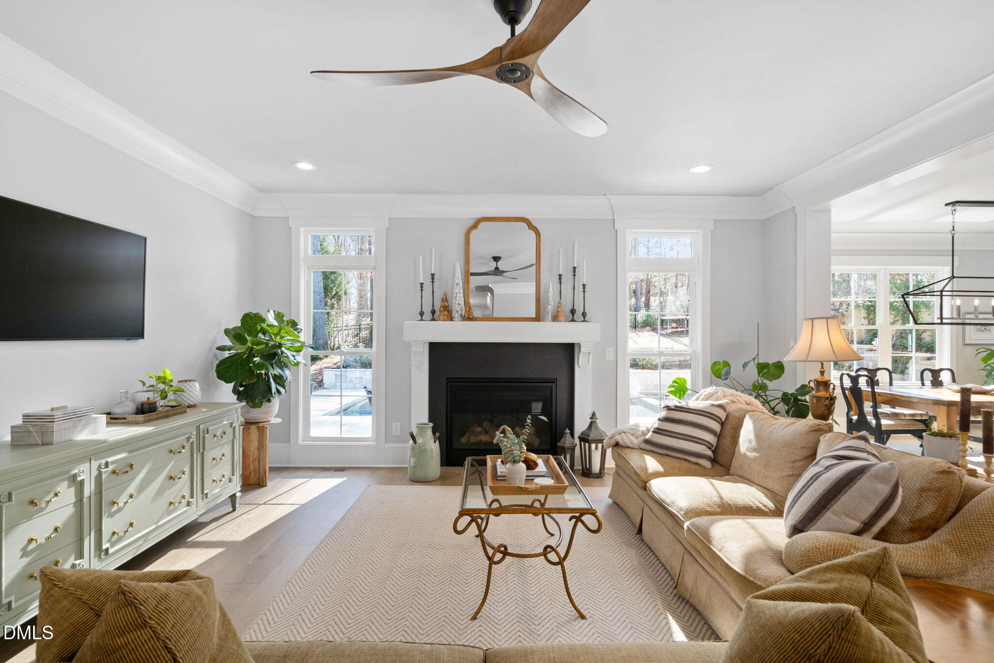 3417 Edgemont Drive Raleigh, NC 27612 - Photo 18 of 70 a living room with furniture a fireplace and a flat screen tv