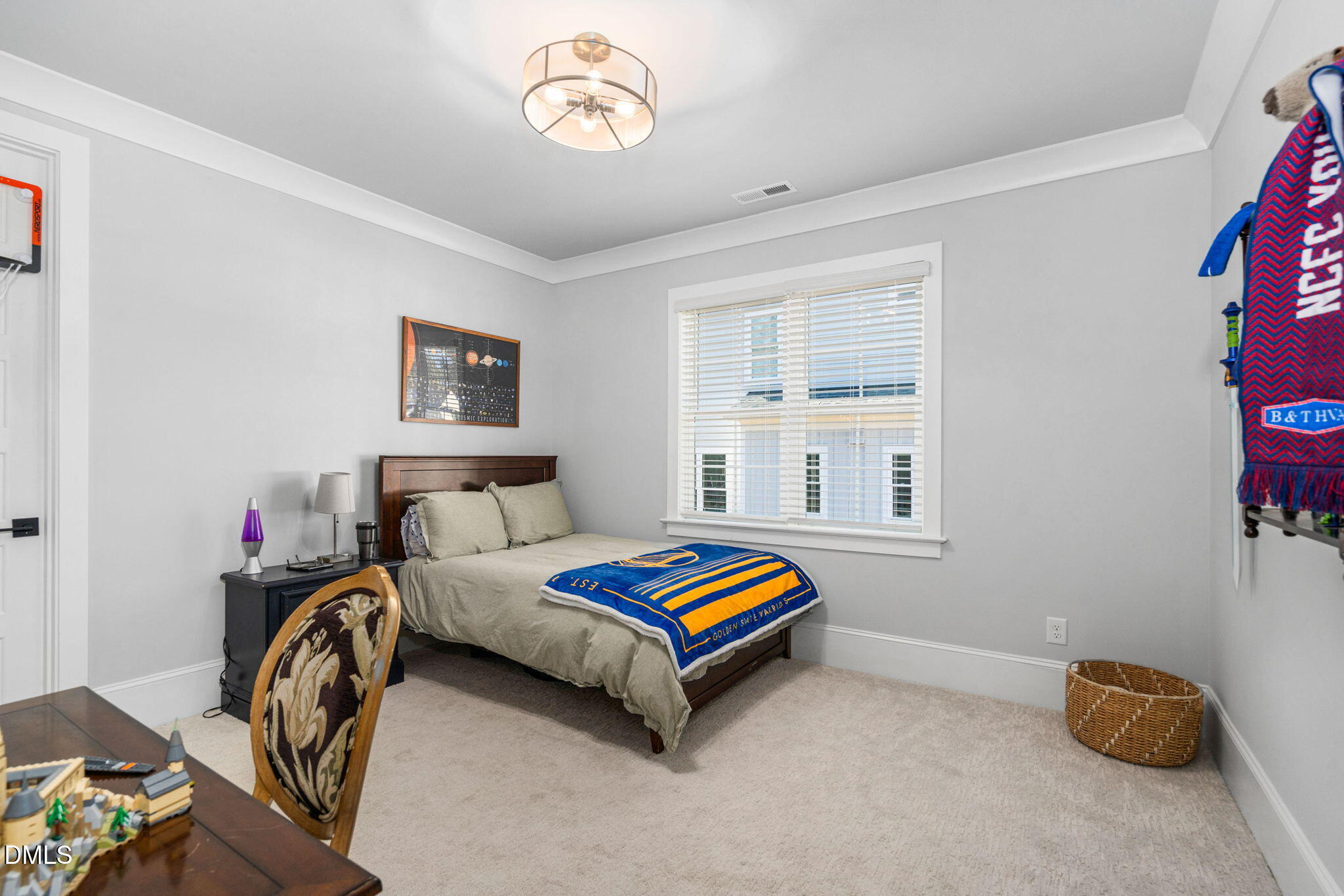 3417 Edgemont Drive Raleigh, NC 27612 - Photo 35 of 70 a bedroom with a bed and a chandelier