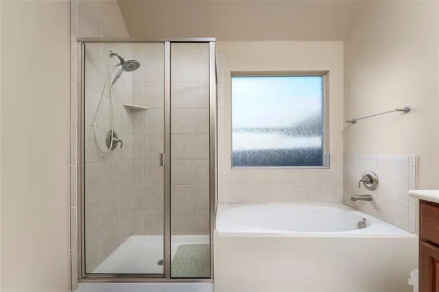 a bathroom with a bathtub and a shower