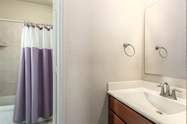 a bathroom with a sink and mirror