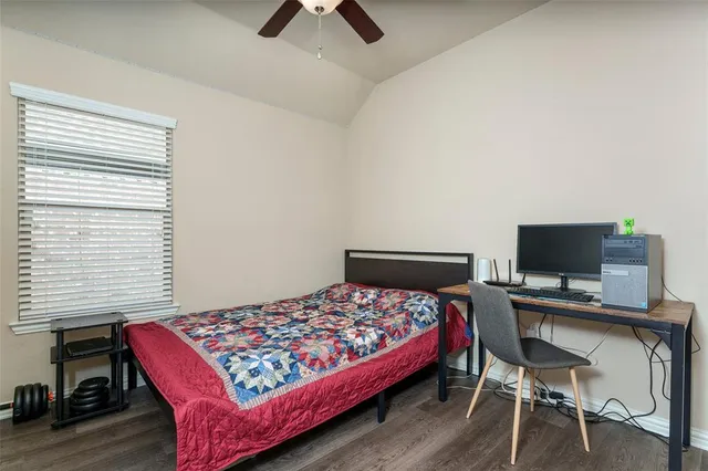 a bedroom with a bed and a desk