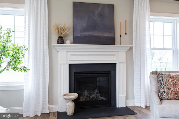 a living room with a fireplace and a window