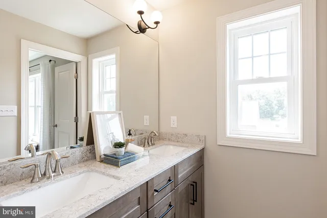 a bathroom with a sink double vanity and a mirror