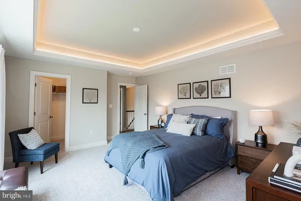 a bedroom with a bed and a couch