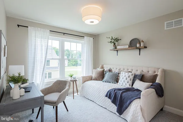 a bedroom with a bed and a chair