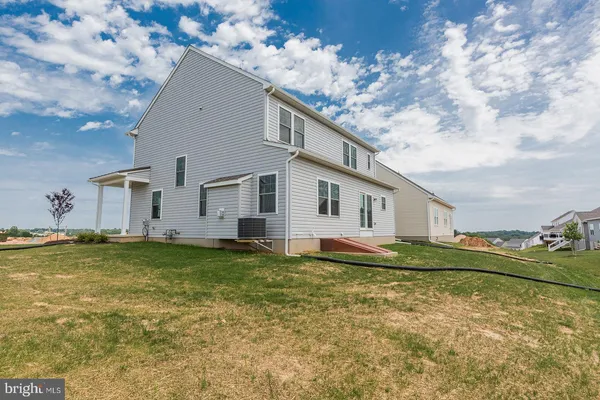 a view of a house with backyard and sitting area