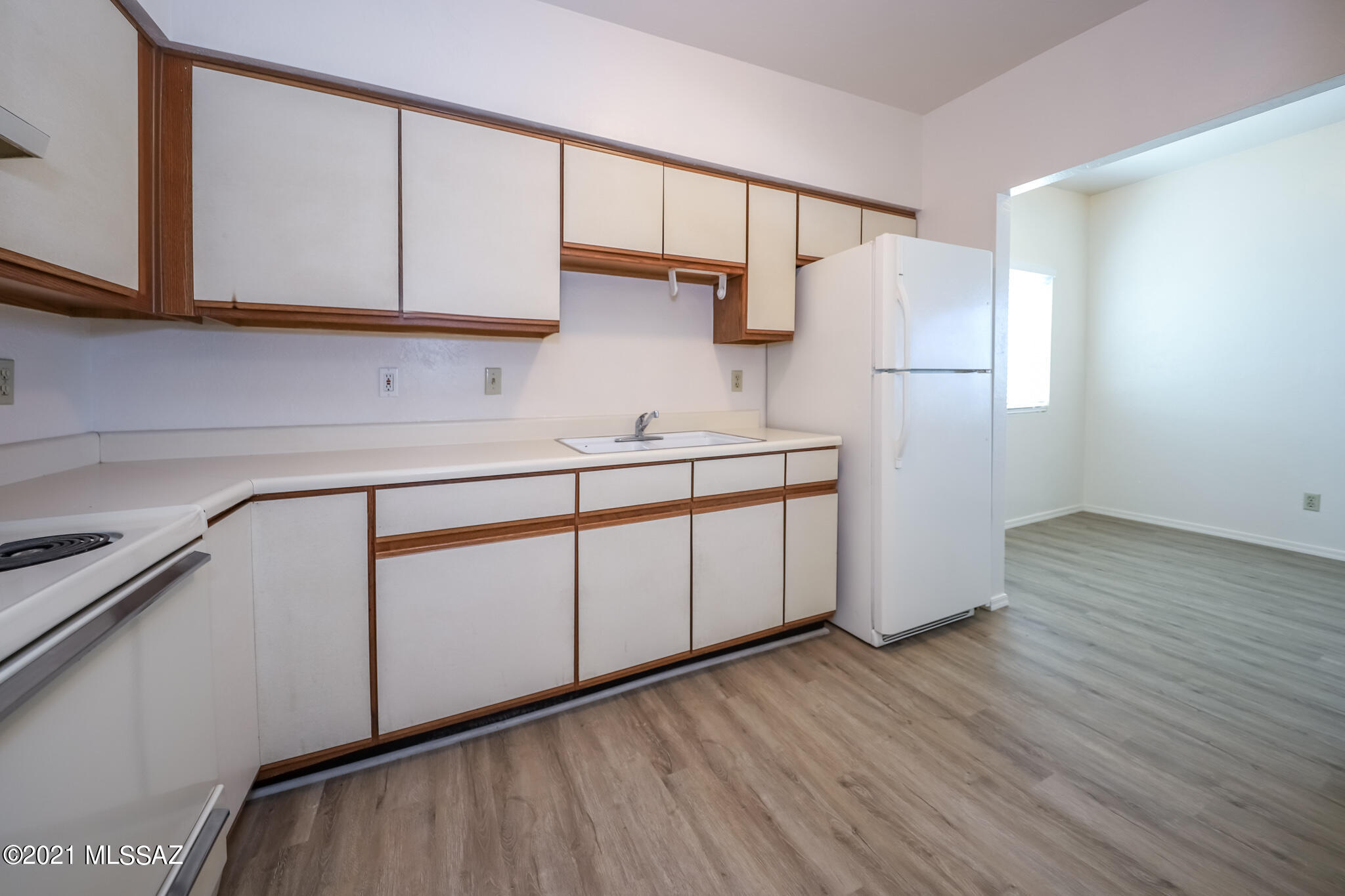 312 East 24th Street, Unit 4 Tucson, AZ 85713 - Photo 1 of 17 a kitchen with a sink a refrigerator and cabinets