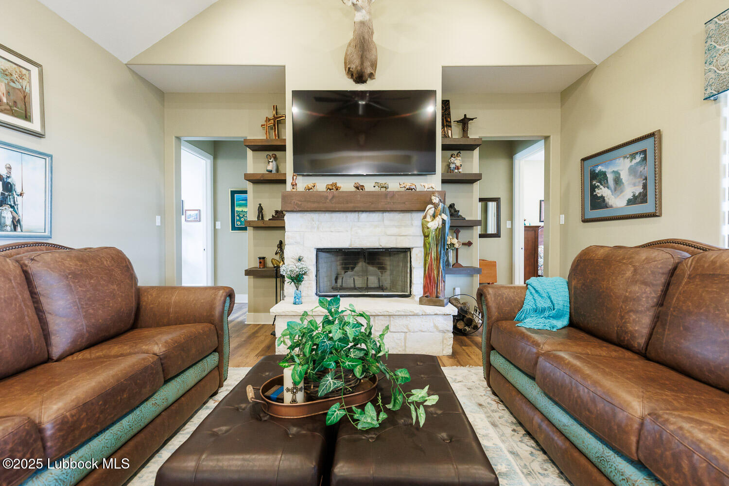 6611 Tiger Ropesville, TX 79358 - Photo 25 of 102 a living room with furniture a flat screen tv and a fireplace