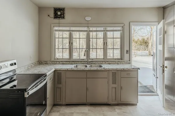 a kitchen with a sink stove and cabinets