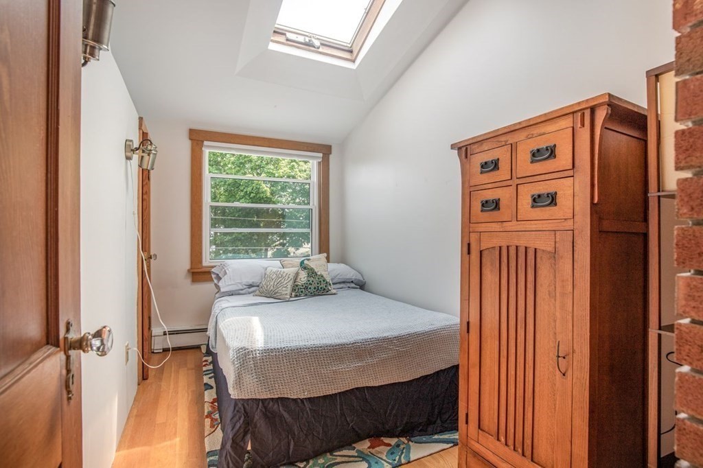 23 Cliff Road Gloucester, MA 01930 - Photo 17 of 37 a bedroom with a bed and a dresser next to a window