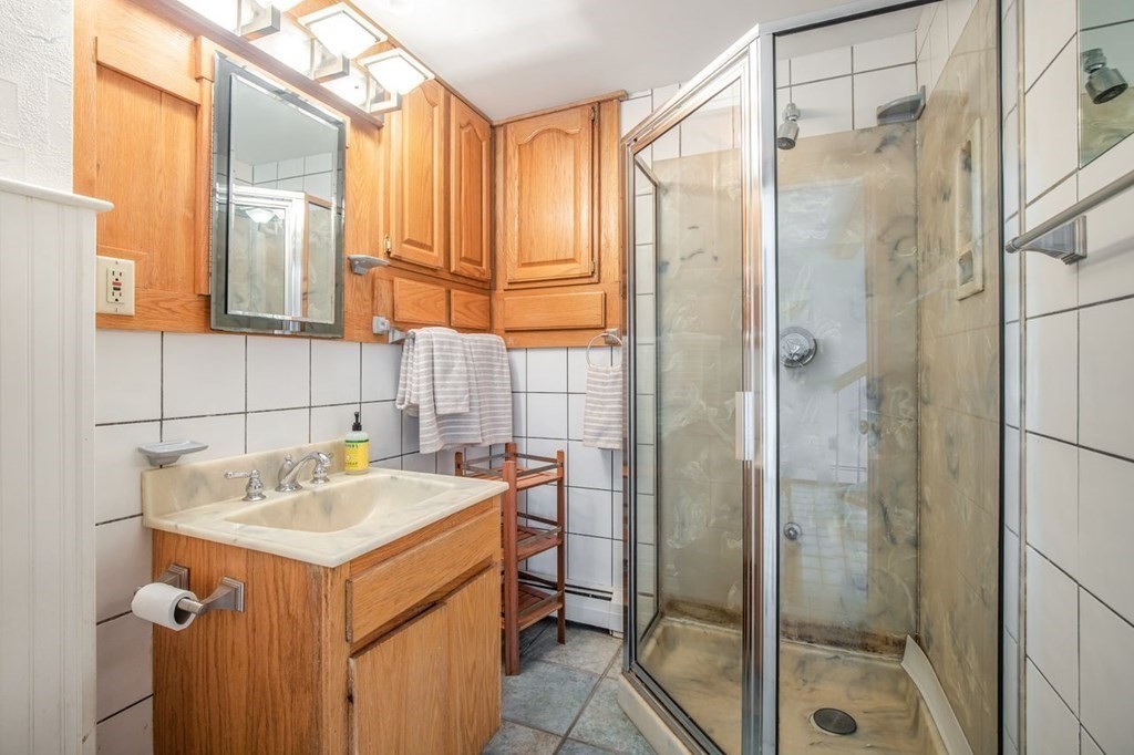 23 Cliff Road Gloucester, MA 01930 - Photo 25 of 37 a bathroom with a sink and mirror