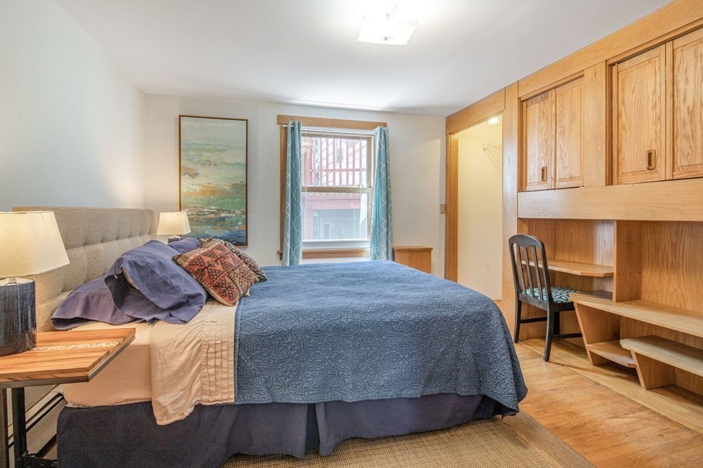 23 Cliff Road Gloucester, MA 01930 - Photo 26 of 37 a bedroom with a bed and wooden floor