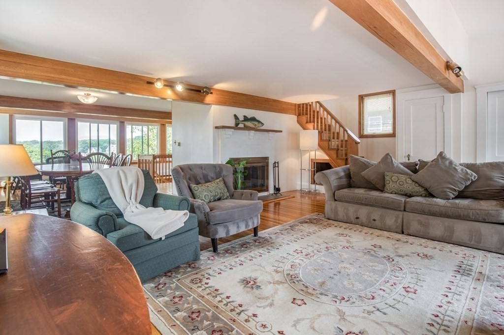 23 Cliff Road Gloucester, MA 01930 - Photo 6 of 37 a living room with furniture wooden floor and a fireplace