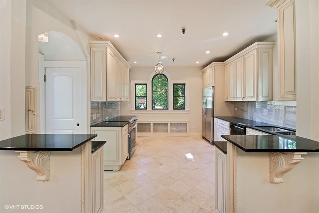 192 Park Avenue Glencoe, IL 60022 - Photo 8 of 24 a kitchen with stainless steel appliances granite countertop a stove a sink and a granite counter tops