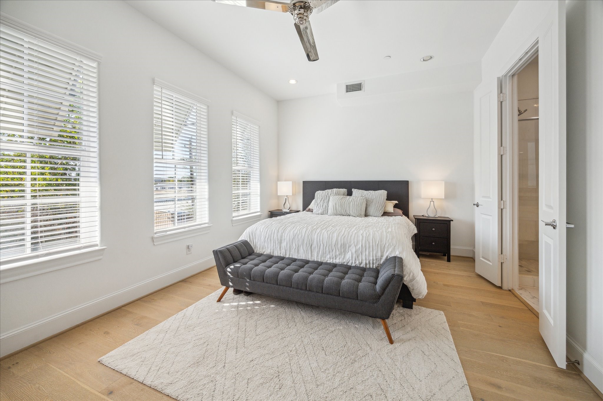 2714 Harvard Street Houston, TX 77008 - Photo 20 of 31 a spacious bedroom with a bed and wooden floor