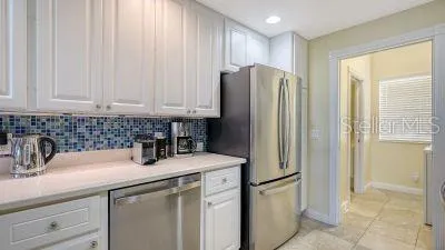 a kitchen with a stove cabinets and microwave