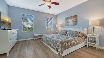 a bedroom with furniture and a flat screen tv