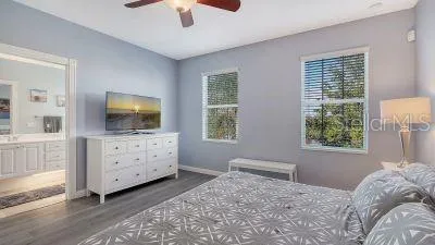 a bedroom with a large bed and a chandelier