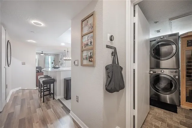 a utility room with wooden floor washer and dryer