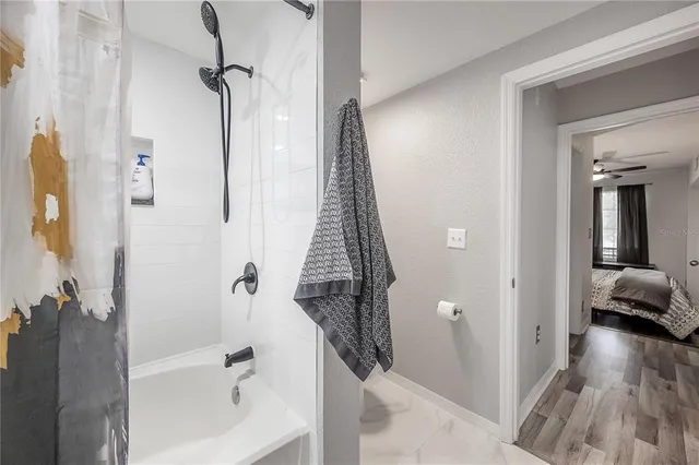 a view of a hallway with wooden floor