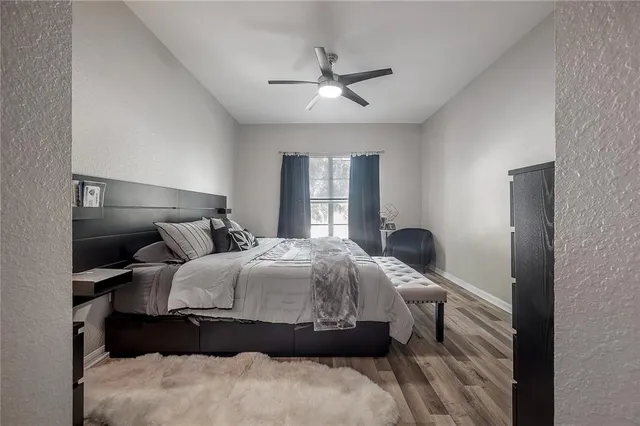 a bedroom with a bed and a chandelier