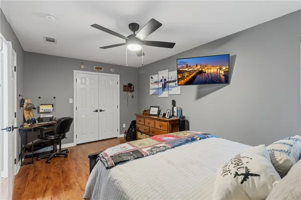 a bedroom with a bed and a chandelier