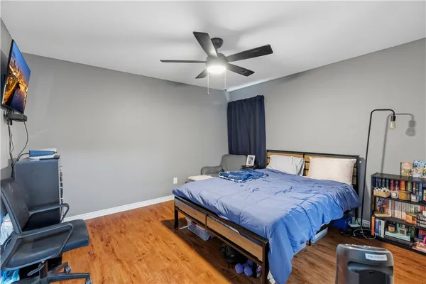 a bedroom with a bed and a bookshelf