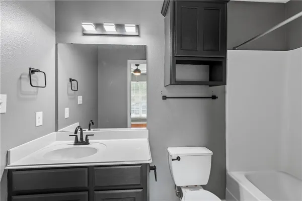 a bathroom with a sink toilet and tub