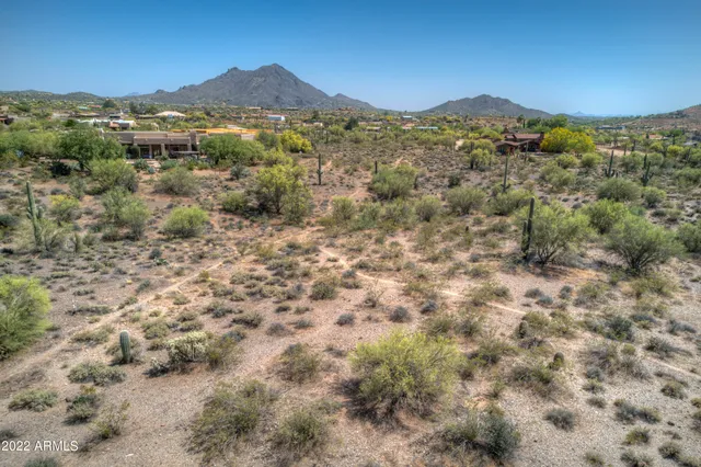 a view of a mountain in the distance in a field