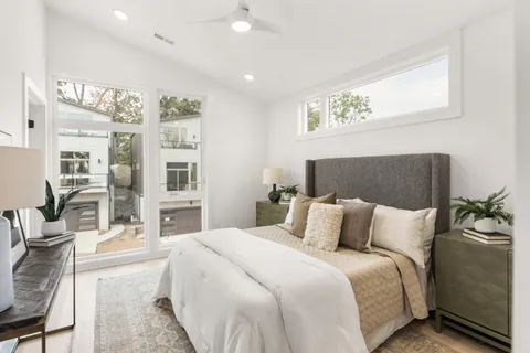 a bedroom with a large bed and a night stand