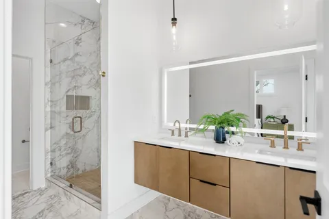 a bathroom with a shower sink and mirror
