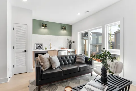 a living room with furniture wooden floor and a fireplace