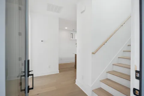 a view of entryway with hallway and stairs