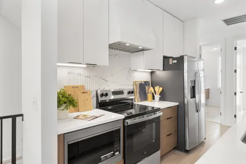 a kitchen with stainless steel appliances granite countertop a stove and a refrigerator