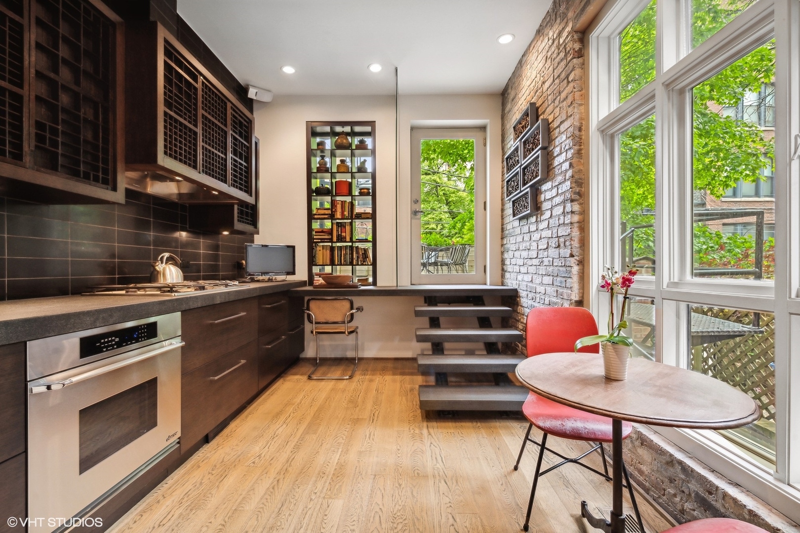 24 East Division Street Chicago, IL 60610 - Photo 18 of 52 a kitchen with a table chairs stove and cabinets