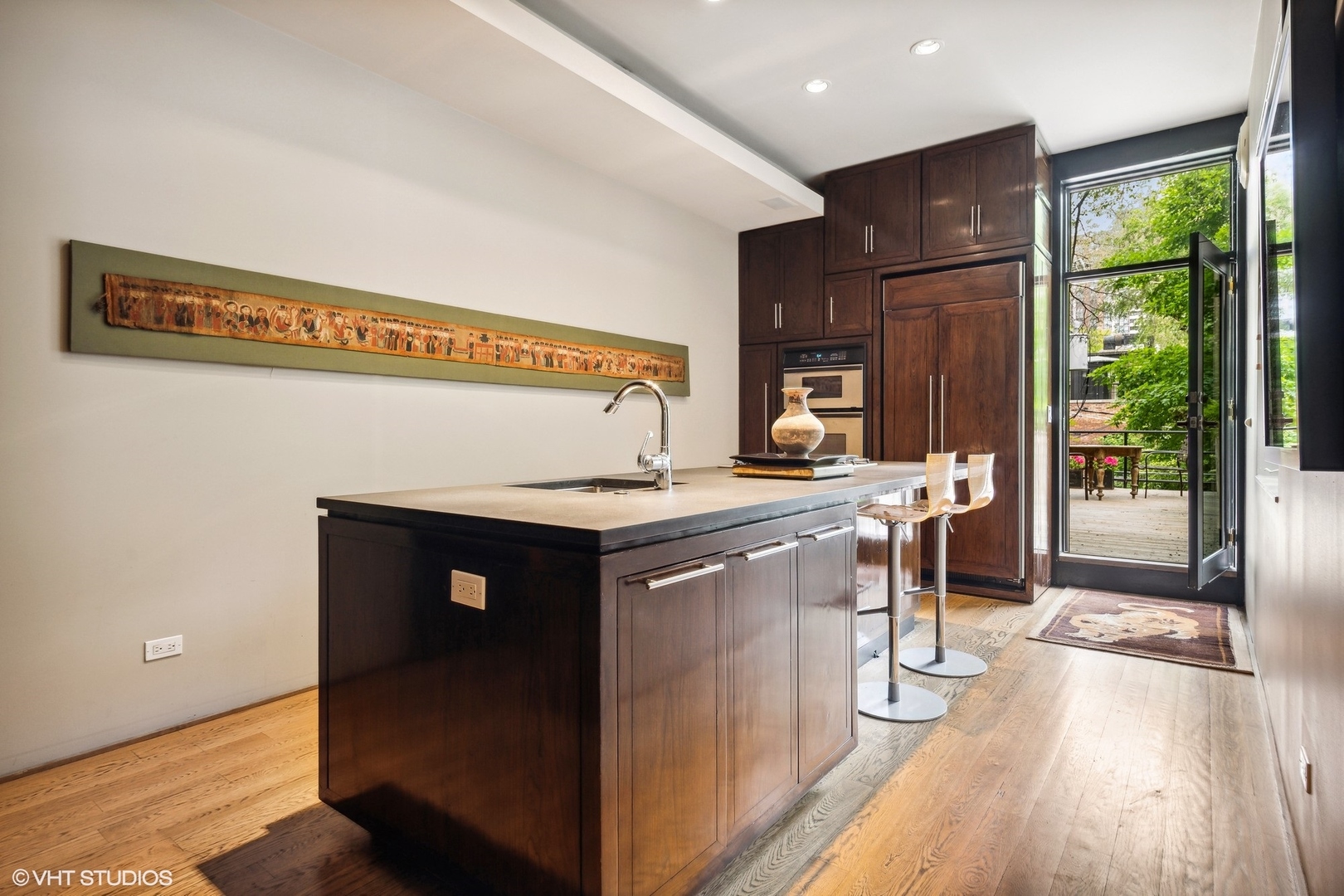 24 East Division Street Chicago, IL 60610 - Photo 24 of 52 a kitchen with a sink cabinets and wooden floor