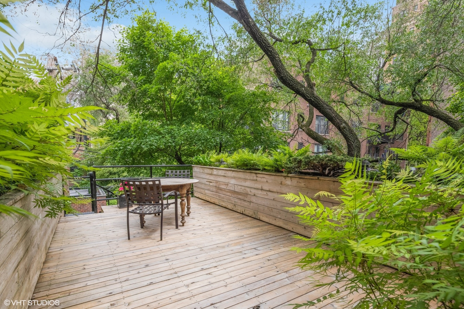 24 East Division Street Chicago, IL 60610 - Photo 25 of 52 a balcony with wooden floor table and chairs
