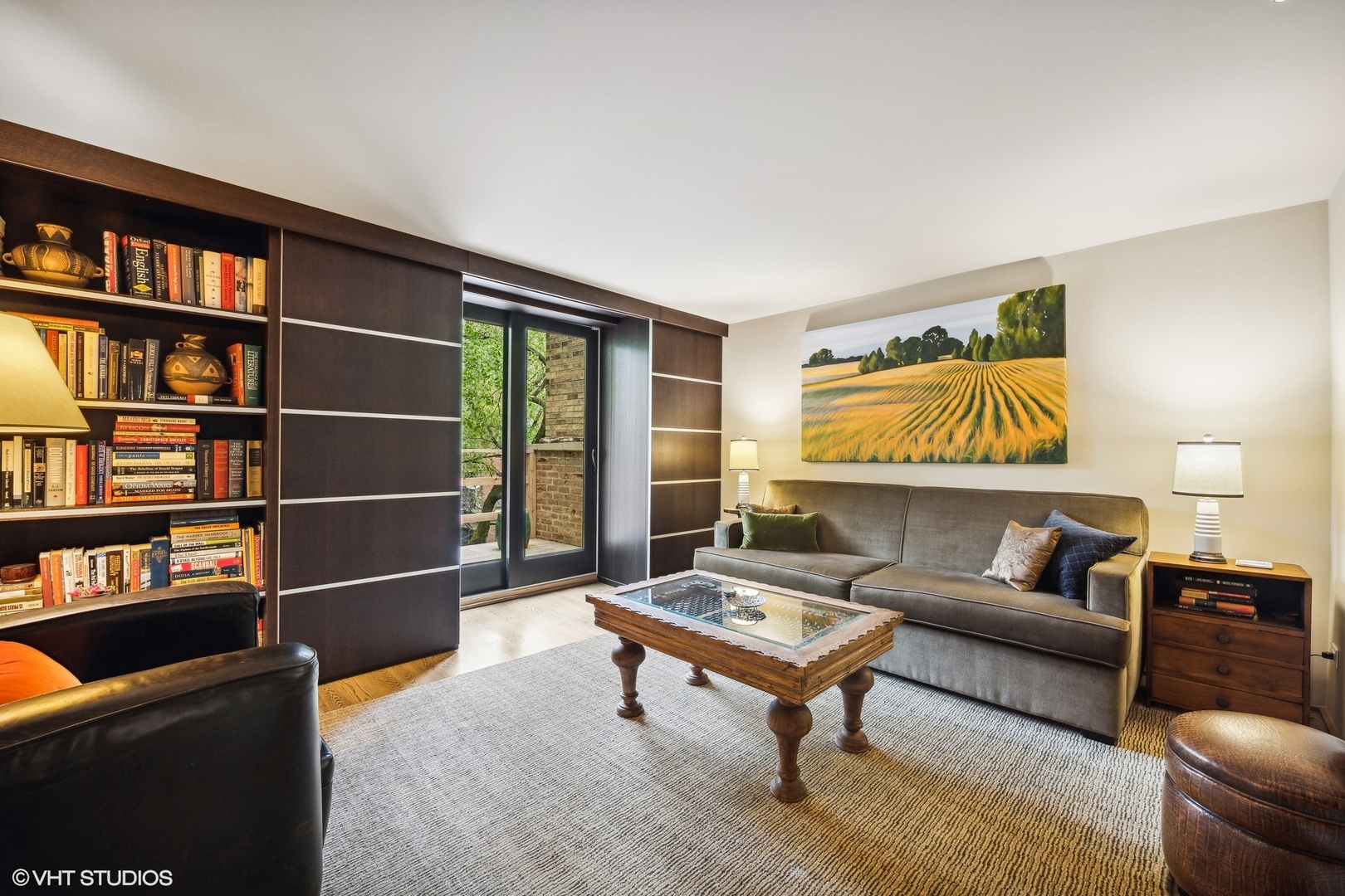 24 East Division Street Chicago, IL 60610 - Photo 28 of 52 a living room with furniture a rug and a book shelf