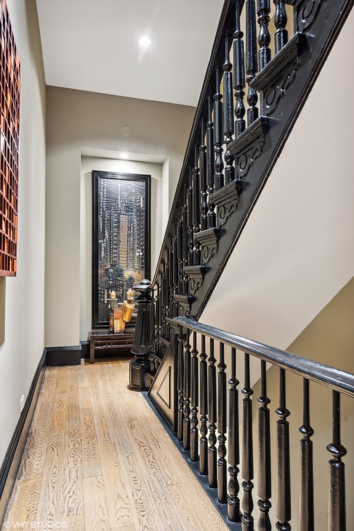 24 East Division Street Chicago, IL 60610 - Photo 42 of 52 a view of staircase with wooden floor and a chandelier
